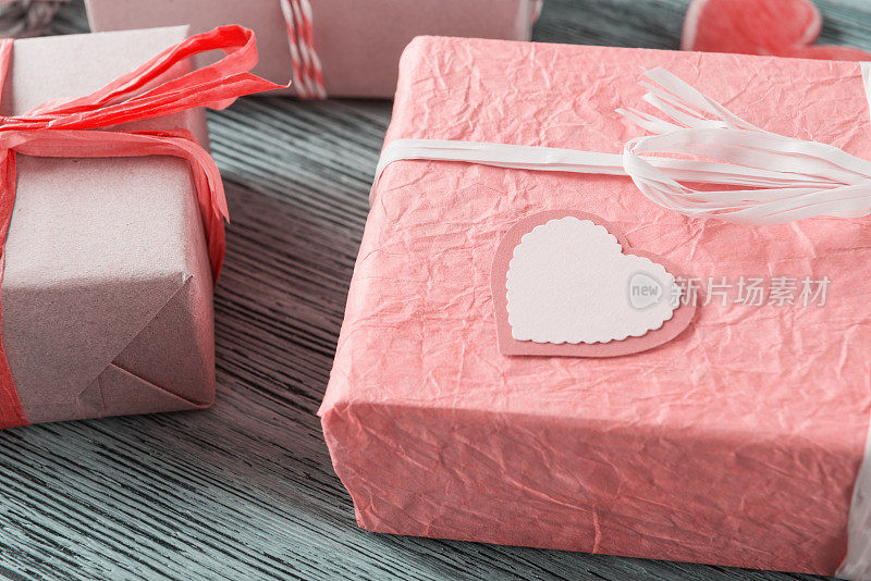 Craft gift boxes and Valentines heart on wooden background. Valentineâs day gift concept. Eco friendly packaging